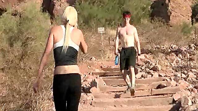 Blonde, well-shaped babe is undressing, while exercising outdoors